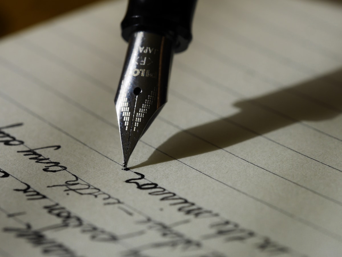 Notebook with handwritten CV personal statement draft on a desk