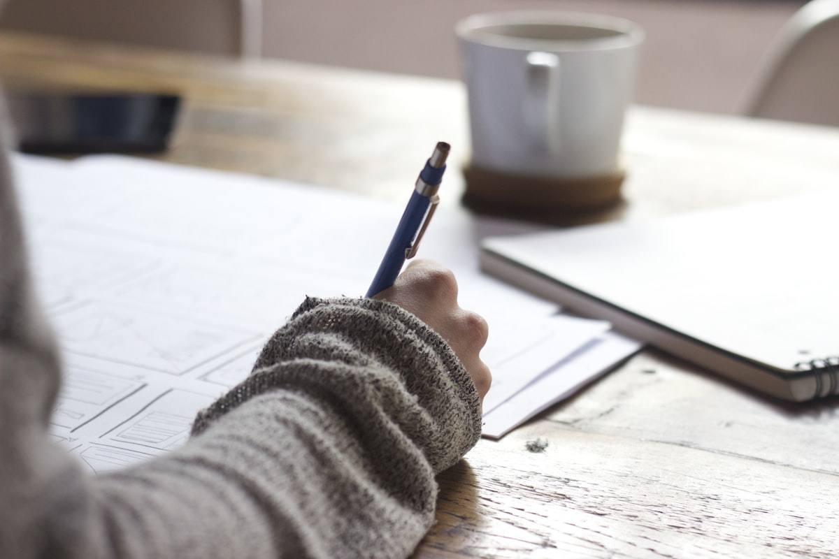 Notebook on a desk with interview prep notes and pen